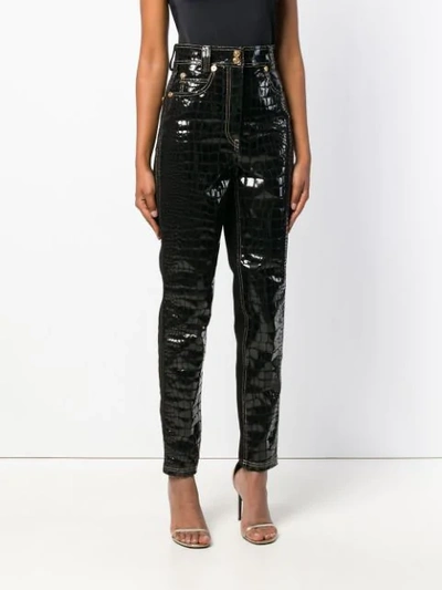 Shop Versace Croco-embossed Trousers - Black