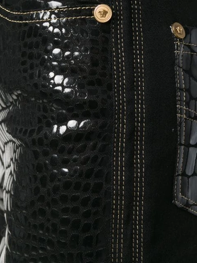 Shop Versace Croco-embossed Trousers - Black