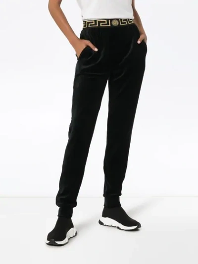 Shop Versace Greek Key-trimmed Velvet Joggers In Black