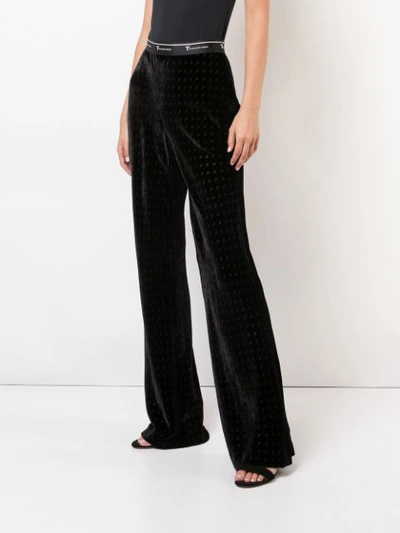 Shop Alexander Wang T Monogram Print Flared Trousers In Black