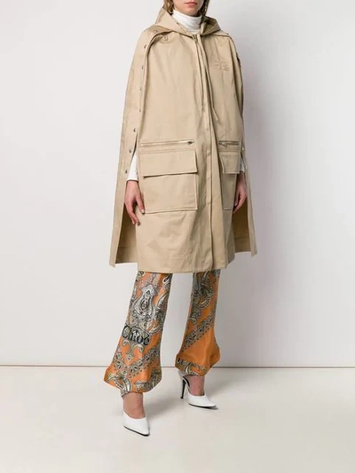 Shop Courrèges Hooded Trench Cape In Neutrals