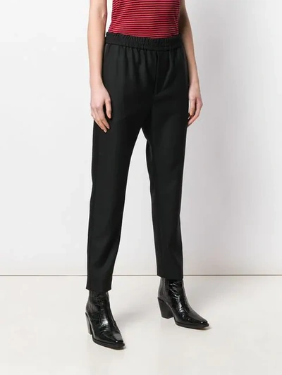 Shop Saint Laurent Stretch Waist Slim-fit Trousers In Black