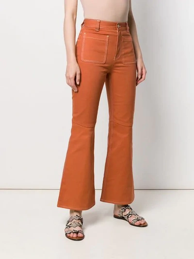 Shop See By Chloé Contrast Stitch Flared Trousers In Orange