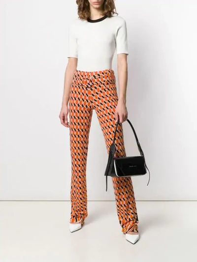 Shop Prada Printed Flared Trousers In Orange