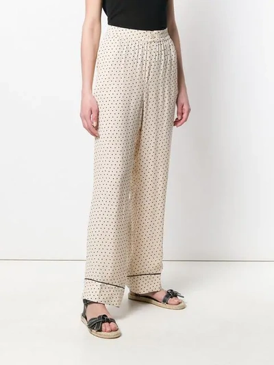 Shop Ganni Dotted Print Trousers In Neutrals