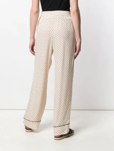Shop Ganni Dotted Print Trousers In Neutrals