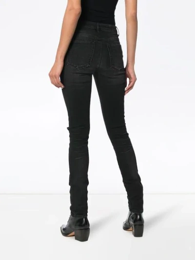 Shop Saint Laurent Ripped Skinny Jeans In Black