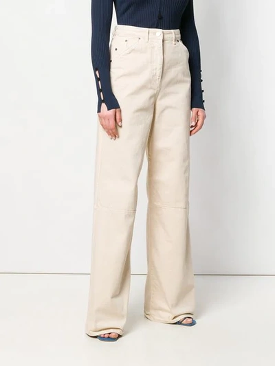 Shop Jacquemus Flared Jeans In Neutrals