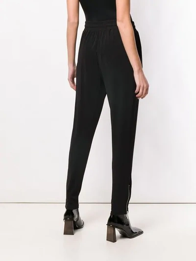 Shop Michael Michael Kors Tapered Ankle Zip Track Trousers In Black