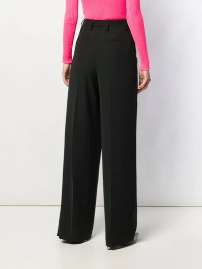 Shop Prada Pleated Detail Trousers In Black