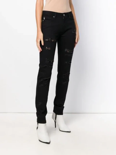 Shop Love Moschino Distressed Skinny Jeans In Black