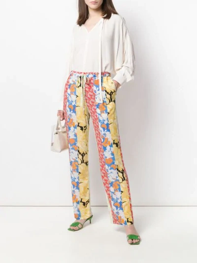 Shop Stine Goya Aileen Floral Print Trousers In Red