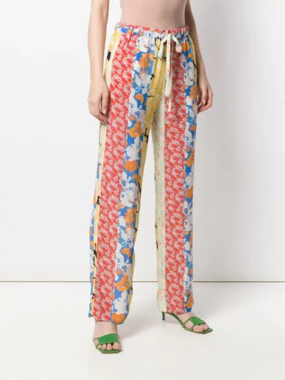 Shop Stine Goya Aileen Floral Print Trousers In Red