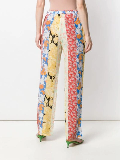 Shop Stine Goya Aileen Floral Print Trousers In Red