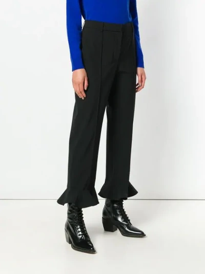 Shop Valentino Ruffled Cuff Trousers In Black