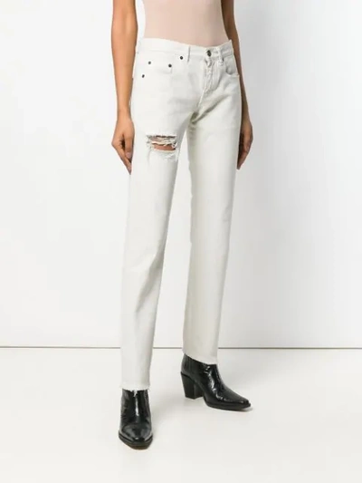 Shop Saint Laurent Distressed Boyfriend Jeans In White