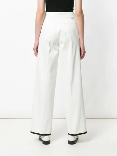 Shop Moncler Flared Style Trousers In White
