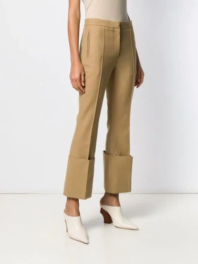 Shop Rokh Cropped Flared Trousers In Neutrals