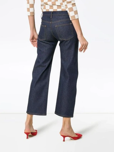 Shop Khaite Wendell Cropped Wide-leg Cotton-blend Jeans In Blue