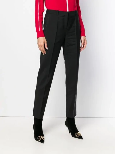 Shop Givenchy Tapered Trousers In Black