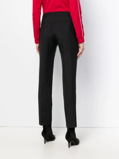 Shop Givenchy Tapered Trousers In Black