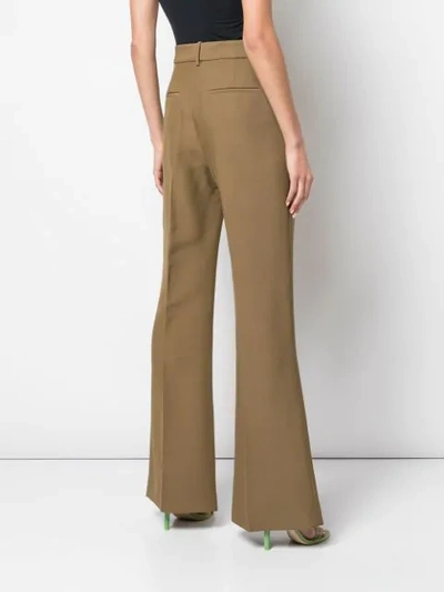 Shop Partow High-rise Flared Trousers In Green