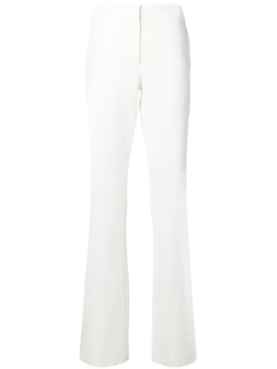 Shop Moschino Bootcut Trousers In White