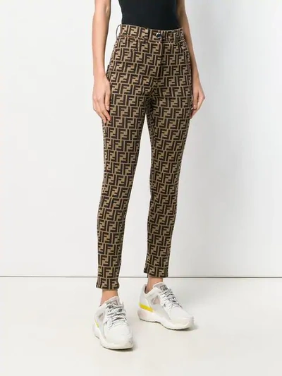Shop Fendi Slim Fit Logo Trousers In Brown