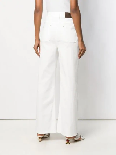 Shop Etro Flared Embroidered Jeans - White