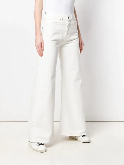 Shop Aspesi Flared Jeans In White