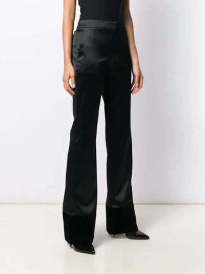 Shop Moschino High-rise Flared Trousers In Black