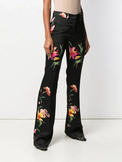 Shop Etro Floral Print Flared Trousers In Black
