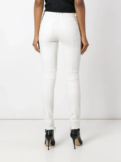 Shop Balmain Button Placket Skinny Jeans - White