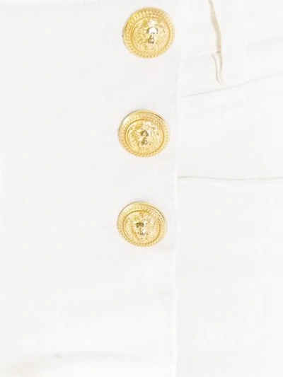 Shop Balmain Button Placket Skinny Jeans - White