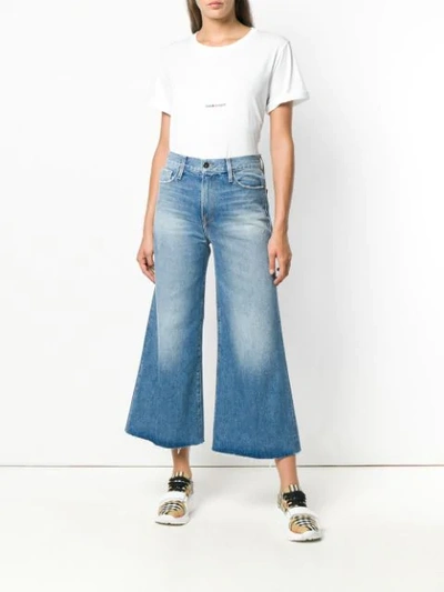 Shop Frame Wide Leg Flared Jeans In Blue