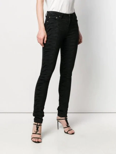 Shop Saint Laurent Zebra Print Jeans In Black