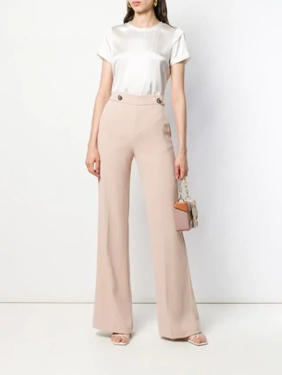 Shop Pinko Button Detail Flare Trousers In Neutrals