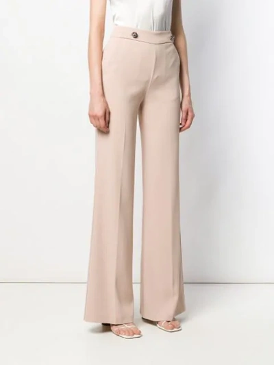 Shop Pinko Button Detail Flare Trousers In Neutrals