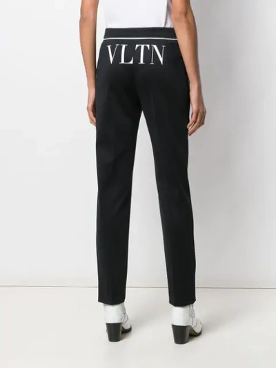 Shop Valentino Vltn Print Trousers In Black