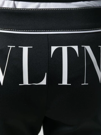 Shop Valentino Vltn Print Trousers In Black