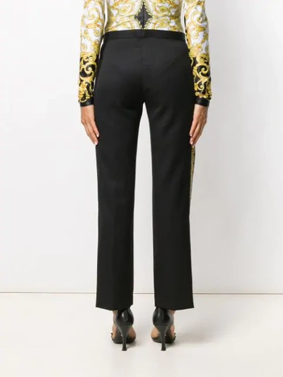 Shop Versace Baroque Print Trousers In Black