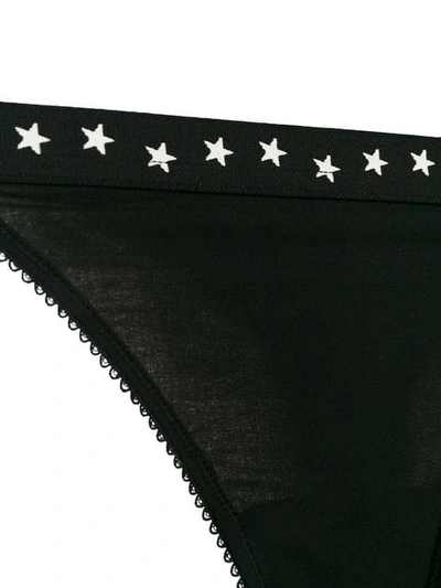 Shop Love Stories Star Print Thongs In Black