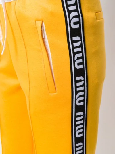 Shop Miu Miu Logo Tape Track Pants In Yellow