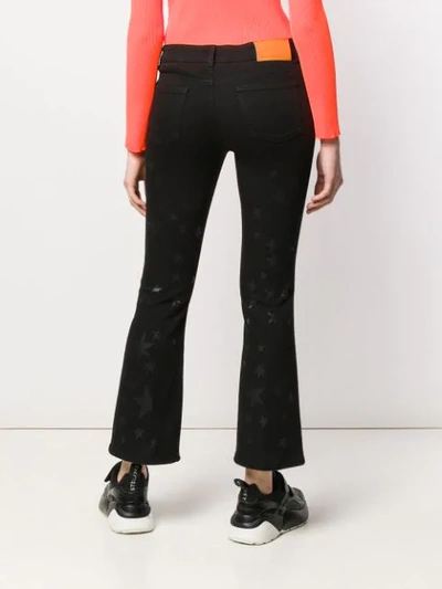 Shop Stella Mccartney Star Print Jeans In Black