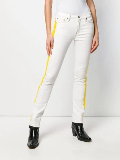 Shop Palm Angels Zipped Cuff Jeans In White