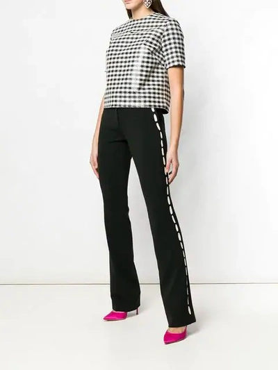 Shop Moschino Contrast Print Trousers In Black