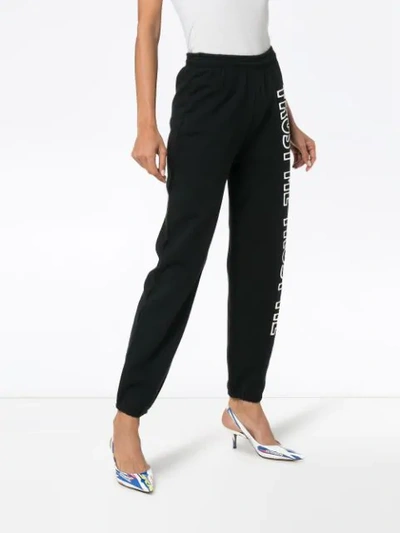 Shop Ashley Williams Text Print Cotton Track Pants In Black