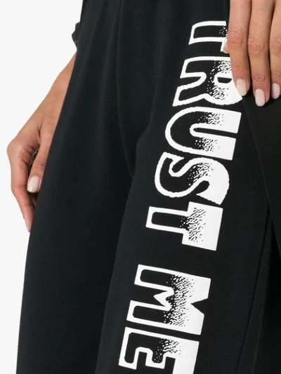 Shop Ashley Williams Text Print Cotton Track Pants In Black