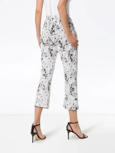 Shop Balmain Cracked-effect Trousers In White