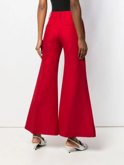 Shop Valentino High Waisted Flared Trousers In Red